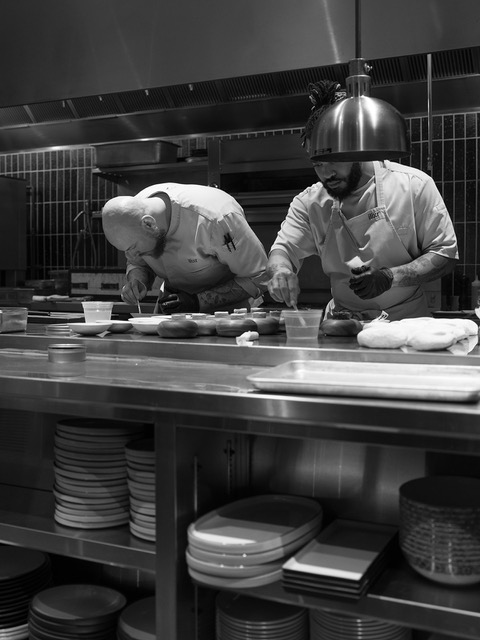 Chefs plating dishes in the kitchen